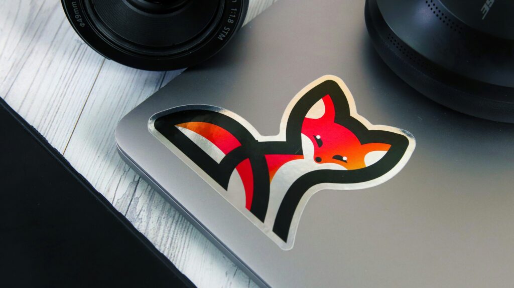 Fox sticker on silver laptop near camera lens